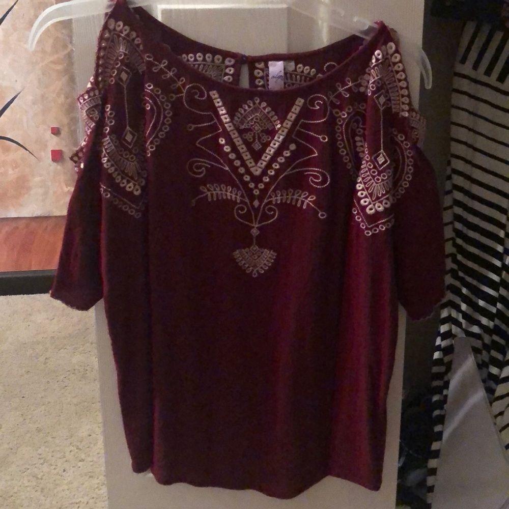 Maroon colored blouse.